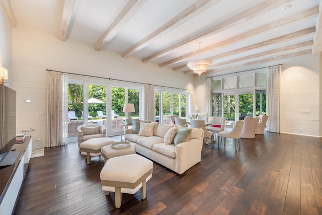 living room featuring dark wood-type flooring, wooden walls, beam ceiling, and french doors