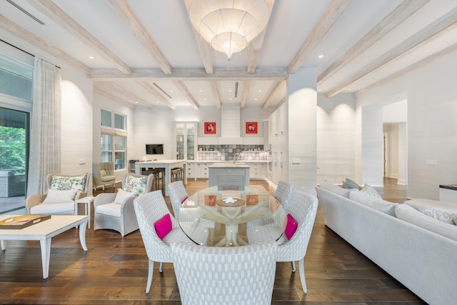 dining area with beam ceiling and dark wood-type flooring