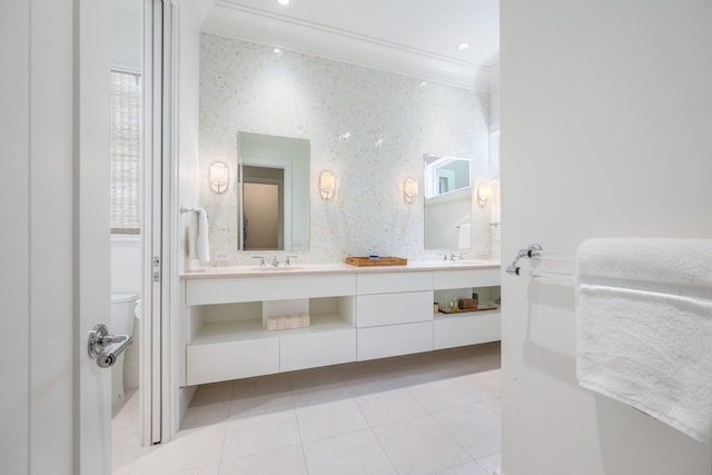 bathroom with crown molding, vanity, toilet, and tile patterned flooring