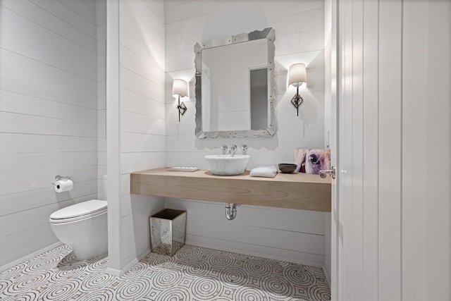 bathroom with tile patterned flooring, sink, and toilet