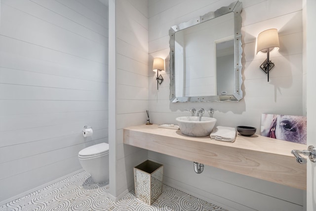 bathroom featuring tile patterned flooring, sink, and toilet