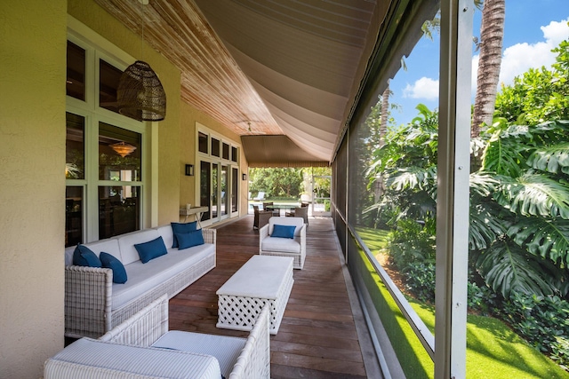 wooden terrace featuring an outdoor living space