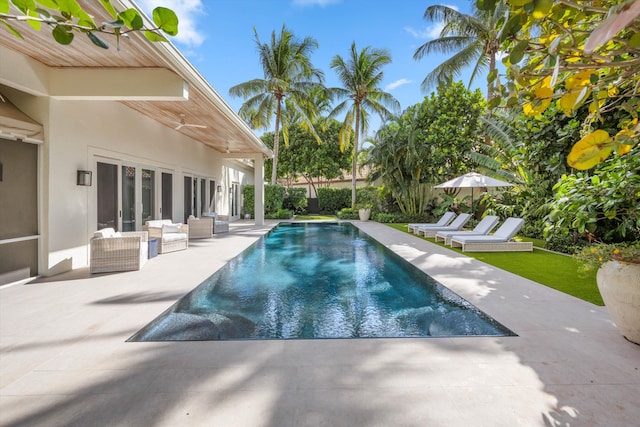 view of pool with outdoor lounge area and a patio