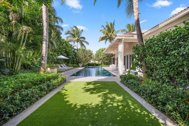 view of pool with a yard and a patio area