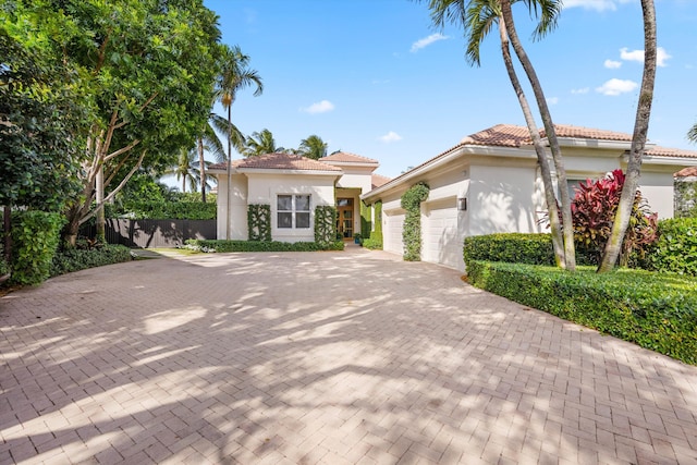 mediterranean / spanish-style home featuring a garage