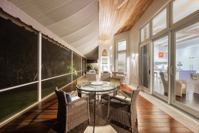 sunroom featuring lofted ceiling and wooden ceiling