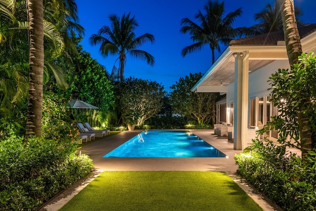 view of pool with a yard and a patio area