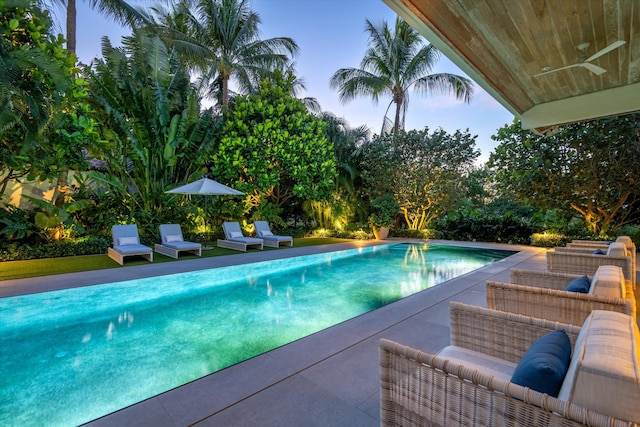 view of swimming pool with ceiling fan, outdoor lounge area, and a patio area