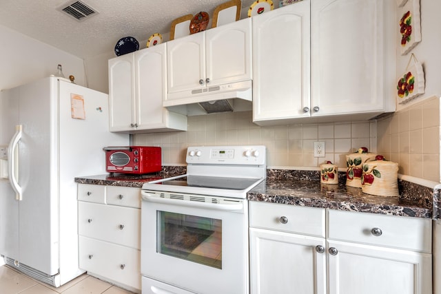 kitchen with tasteful backsplash, white cabinets, dark stone counters, white appliances, and a textured ceiling