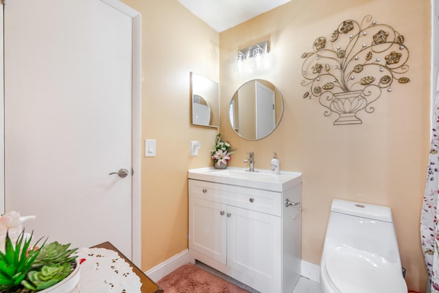 bathroom featuring vanity and toilet