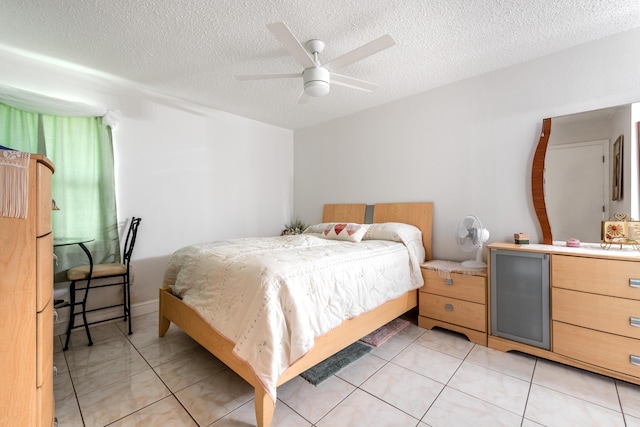 tiled bedroom with ceiling fan and a textured ceiling