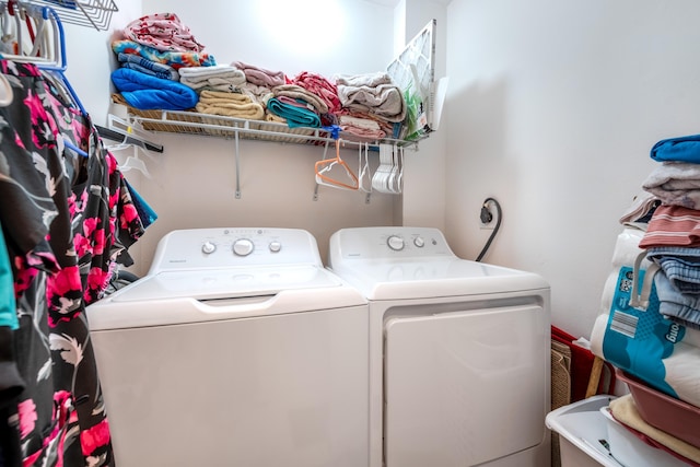 clothes washing area featuring independent washer and dryer