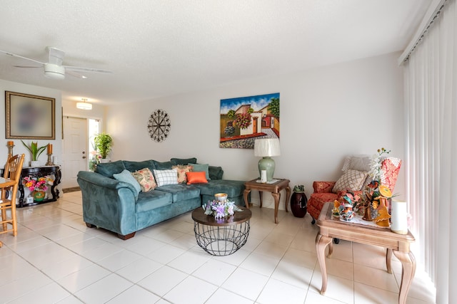 tiled living room with a textured ceiling and ceiling fan