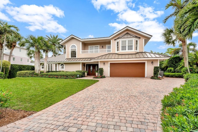 view of front of house with a garage and a front yard