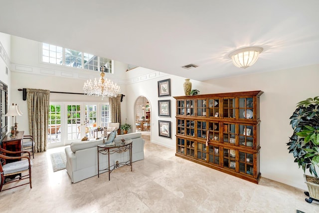 living room featuring an inviting chandelier and french doors