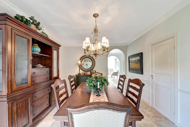 dining space with crown molding and a notable chandelier