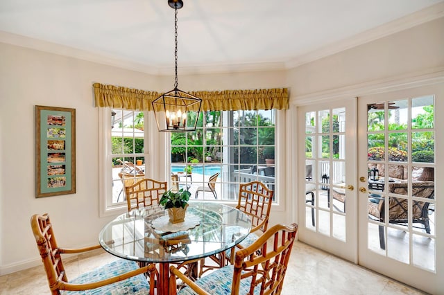 dining space with a notable chandelier, ornamental molding, and french doors