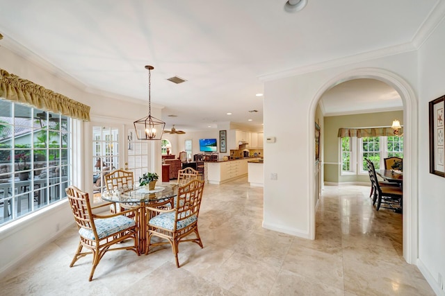 dining area featuring ornamental molding and a chandelier