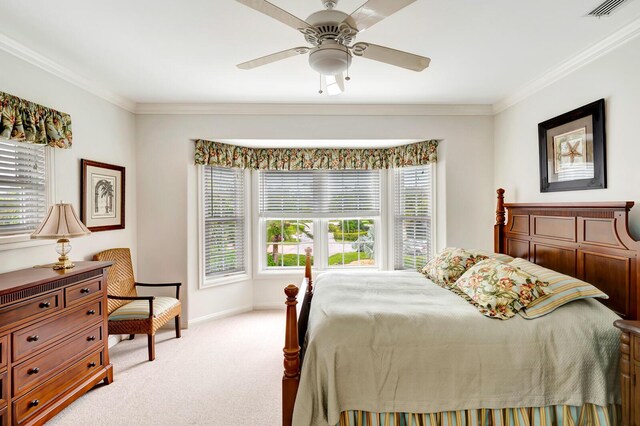 carpeted bedroom featuring ornamental molding and ceiling fan