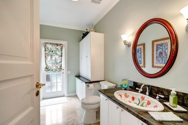 bathroom featuring ornamental molding, vanity, and toilet