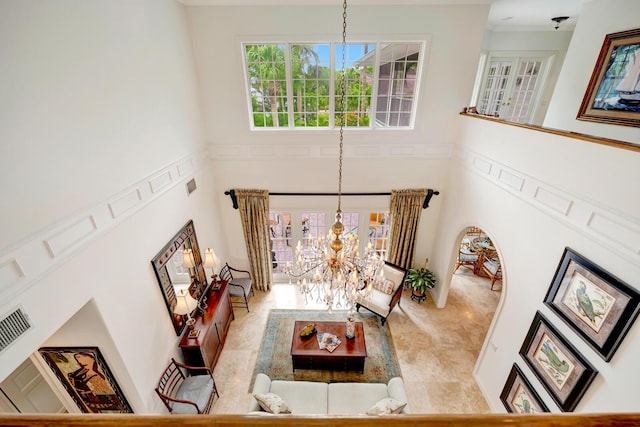 living room with a high ceiling and a chandelier