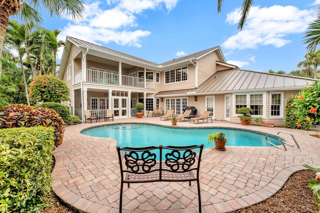 view of pool with a patio and french doors