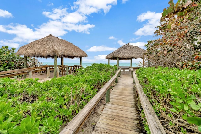 view of dock featuring a gazebo and a water view