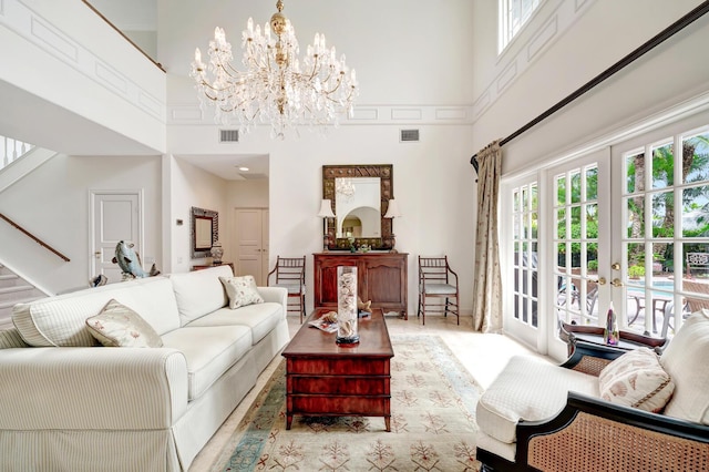 living room featuring french doors, a healthy amount of sunlight, and a high ceiling