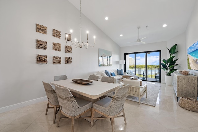 dining space featuring ceiling fan with notable chandelier, high vaulted ceiling, and light tile patterned floors