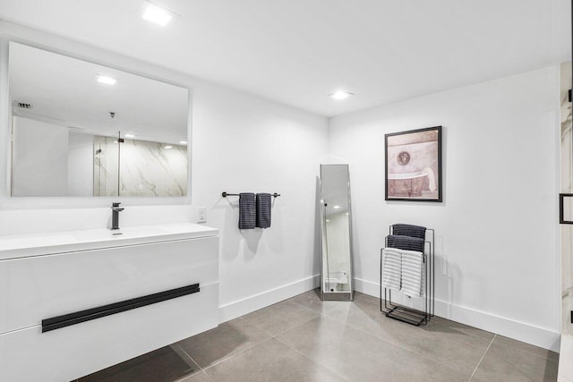 bathroom with vanity, an enclosed shower, and tile patterned flooring