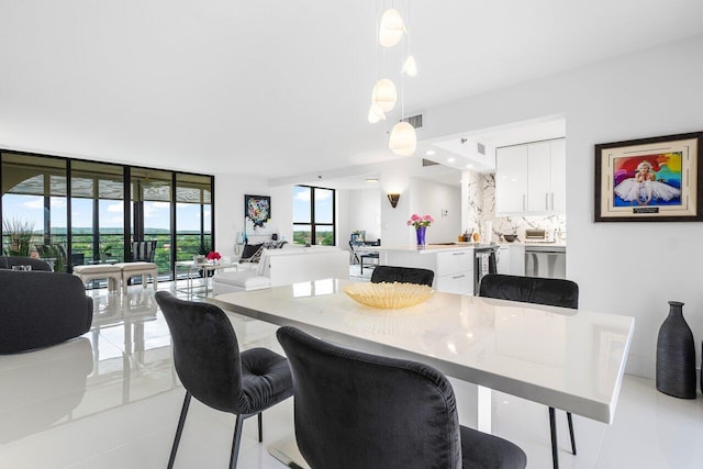 dining space featuring a wall of windows