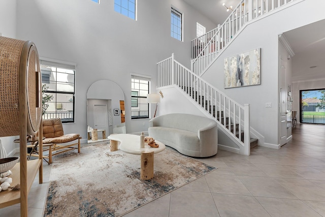 3134 Streng Ln, Royal Palm Beach, FL 33411 - tiled living area with stairs, a towering ceiling, baseboards, and ornamental molding