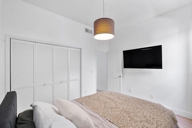 bedroom featuring hardwood / wood-style floors and a closet