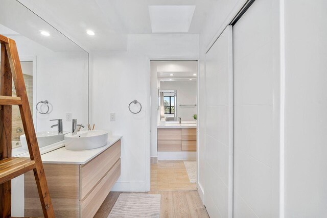 bathroom featuring vanity and hardwood / wood-style floors