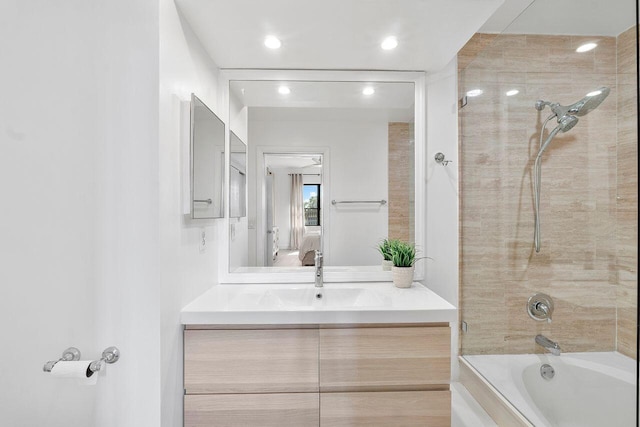 bathroom with vanity and tiled shower / bath combo