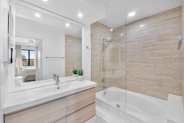 bathroom featuring enclosed tub / shower combo and vanity