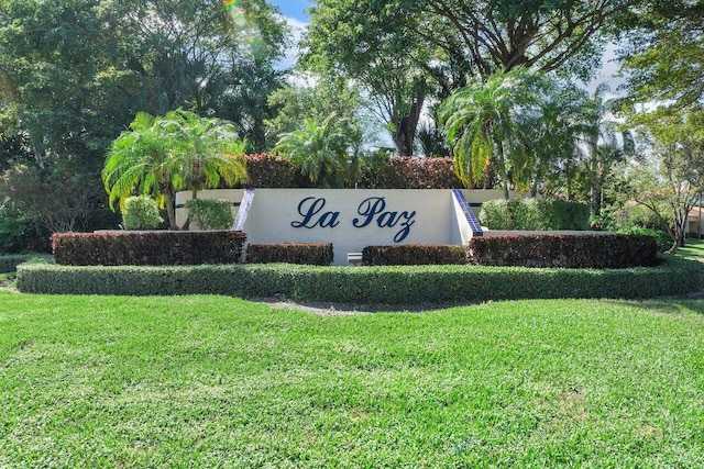 community sign featuring a lawn