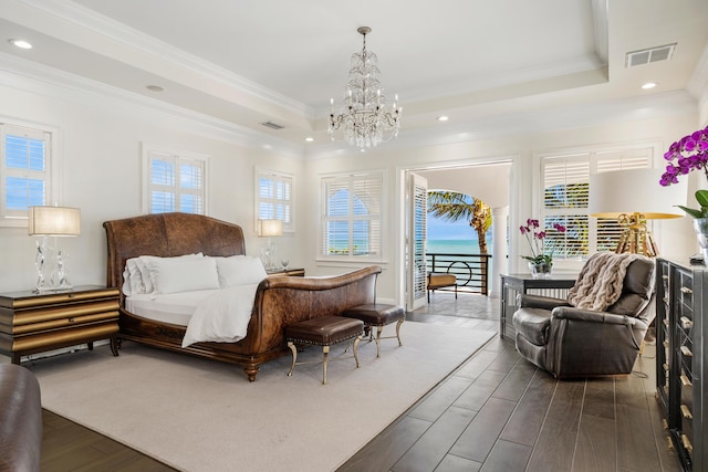 bedroom featuring crown molding, dark wood-type flooring, access to exterior, and a tray ceiling