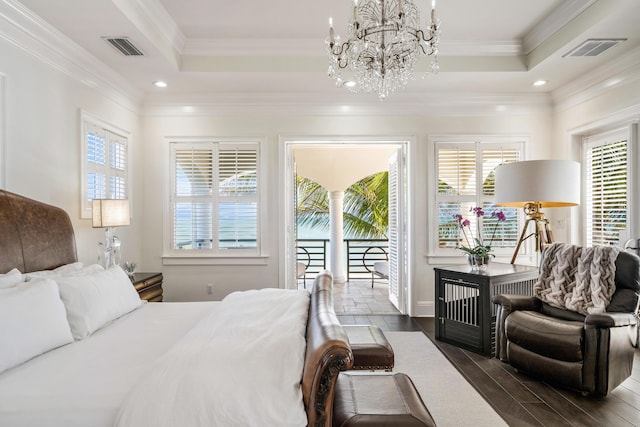 bedroom featuring crown molding, dark hardwood / wood-style floors, a tray ceiling, and access to outside