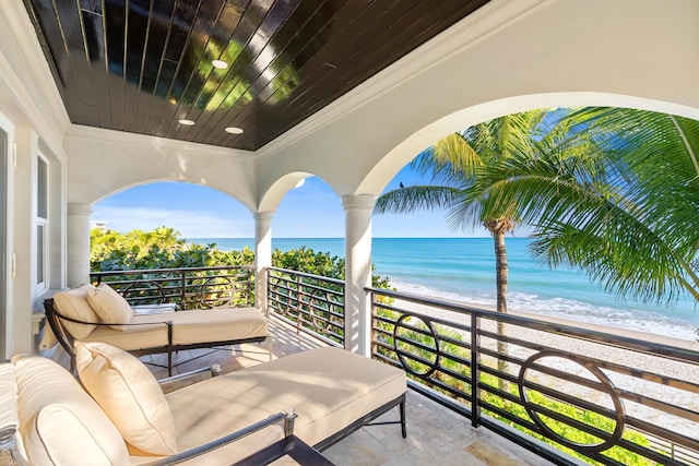 balcony with a view of the beach and a water view