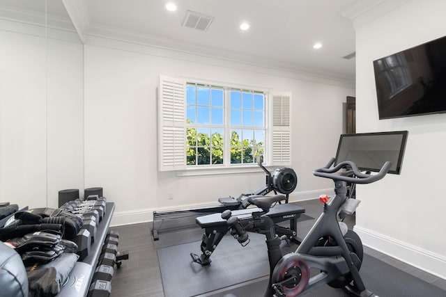 workout area with ornamental molding and wood-type flooring