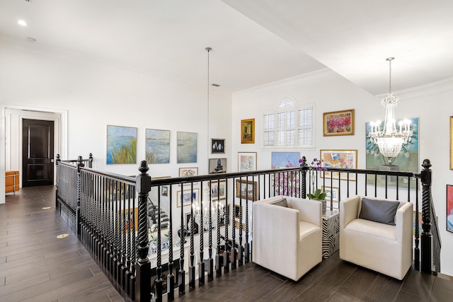 hall featuring a notable chandelier and crown molding