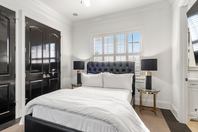 bedroom featuring crown molding and wood-type flooring