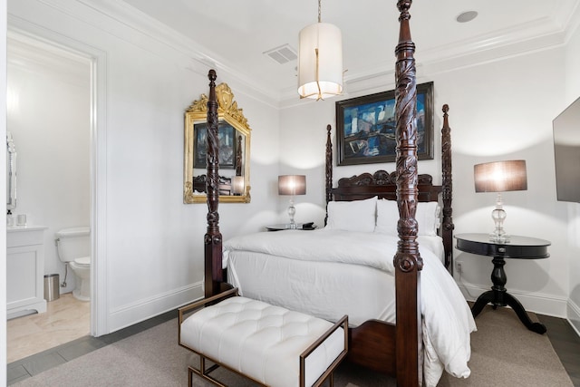 bedroom featuring crown molding and ensuite bath