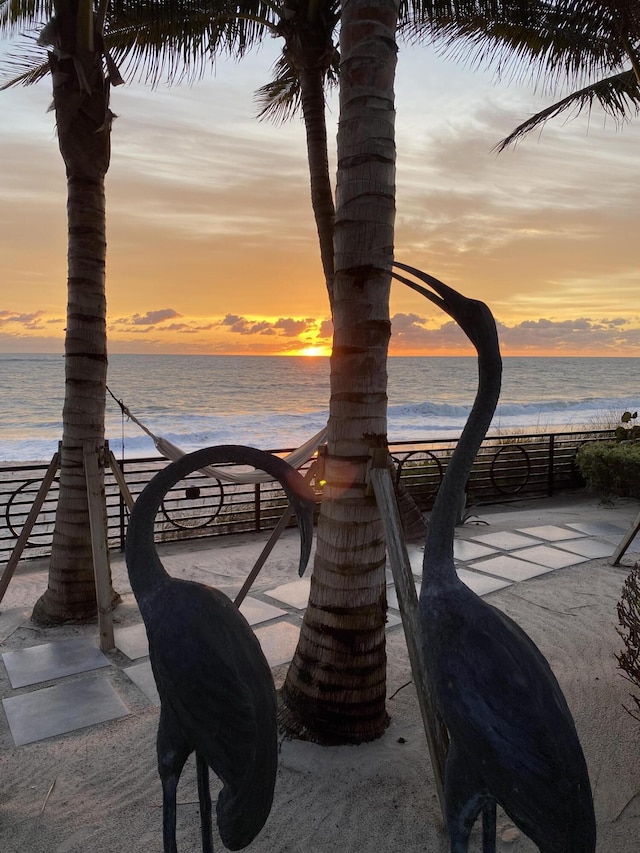 surrounding community featuring a water view and a view of the beach