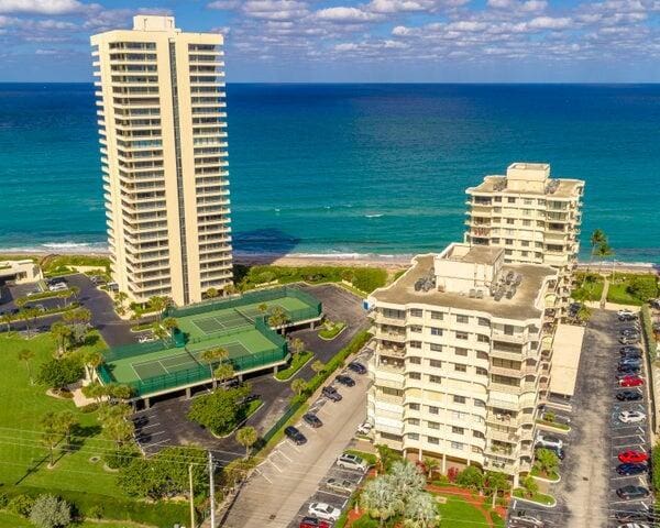 birds eye view of property with a water view and a city view