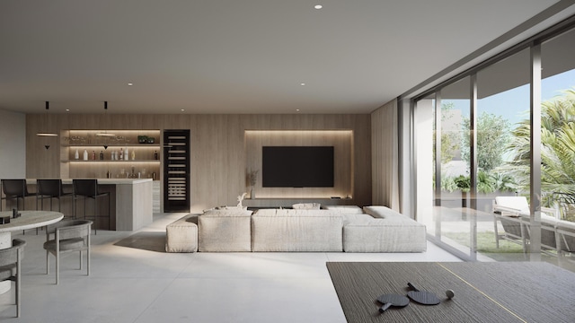 living room featuring wooden walls, floor to ceiling windows, and bar area