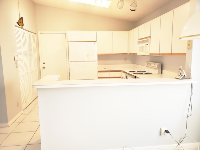 kitchen with lofted ceiling, light tile patterned floors, white appliances, white cabinetry, and kitchen peninsula