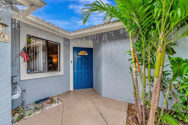 doorway to property with a patio area