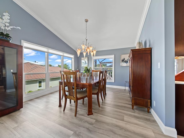 dining area with light wood-type flooring, vaulted ceiling, and ornamental molding